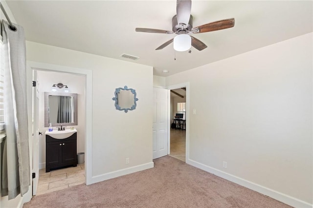 1010 Weber Pkwy, Corpus Christi, TX 78411 - unfurnished bedroom featuring light carpet, a ceiling fan, and ensuite bath