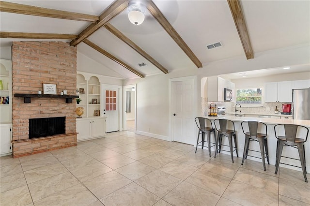 1010 Weber Pkwy, Corpus Christi, TX 78411 - living area featuring a brick fireplace, light tile patterned floors, and built in features