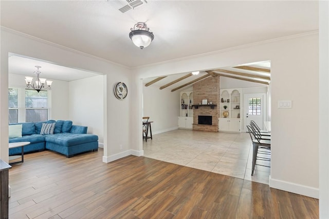 1010 Weber Pkwy, Corpus Christi, TX 78411 - living area featuring plenty of natural light, a fireplace, wood finished floors, a chandelier, and ornamental molding