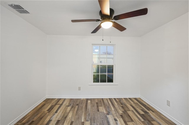 spare room with dark hardwood / wood-style flooring