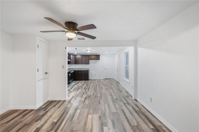 unfurnished living room with wood-type flooring and ceiling fan