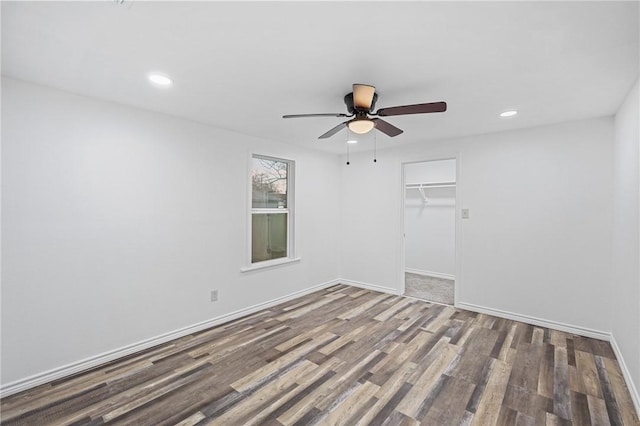 empty room with hardwood / wood-style flooring and ceiling fan