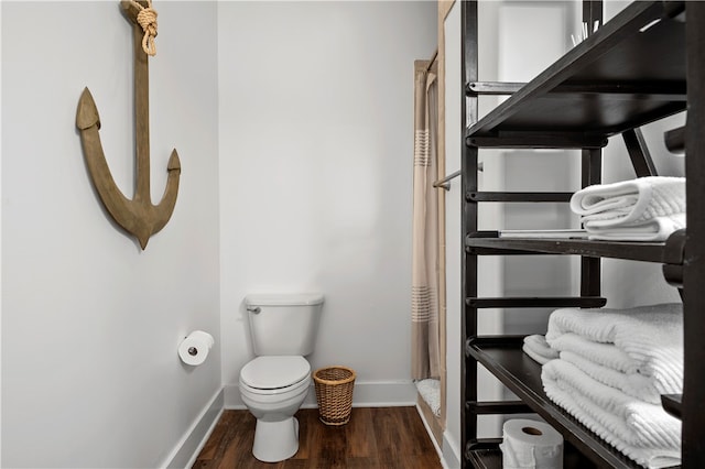 bathroom featuring hardwood / wood-style floors and toilet