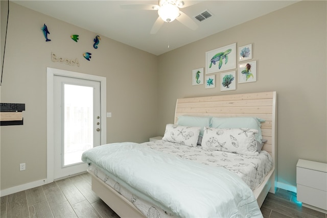 bedroom with ceiling fan and dark hardwood / wood-style floors