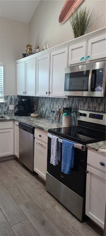 kitchen featuring tasteful backsplash, white cabinetry, appliances with stainless steel finishes, and light hardwood / wood-style floors