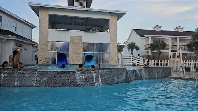 rear view of house with pool water feature