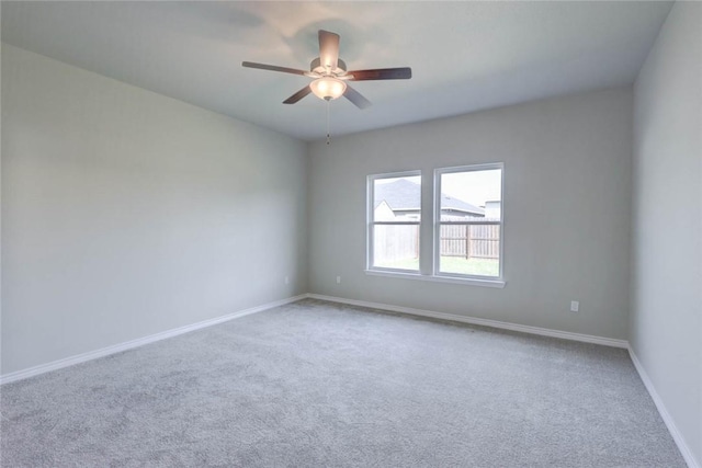 unfurnished room featuring ceiling fan and carpet