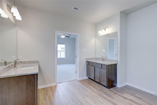 bathroom featuring ceiling fan and vanity