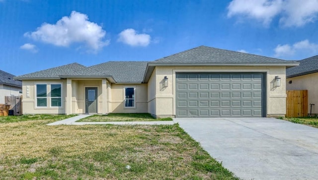 view of front of home with a garage and a front lawn