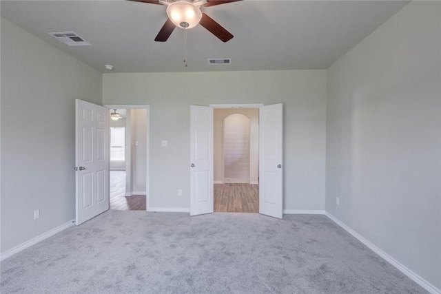 unfurnished bedroom with ceiling fan and light carpet