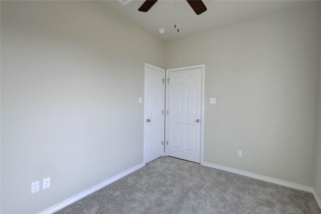 spare room with light carpet and ceiling fan