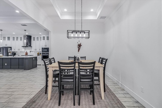 dining area featuring a raised ceiling