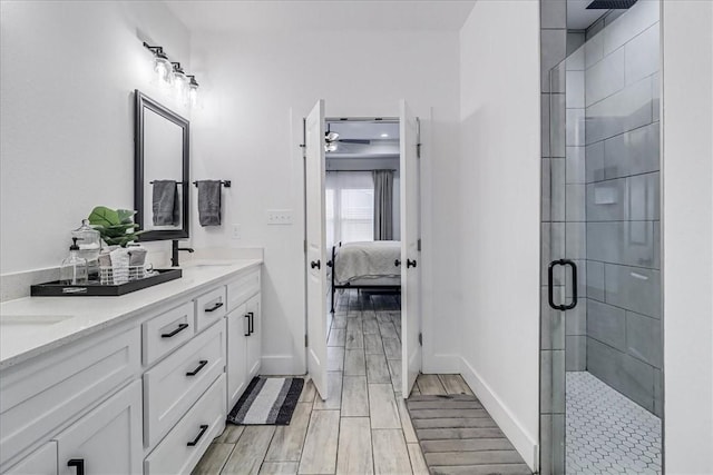 bathroom with a shower with door and vanity