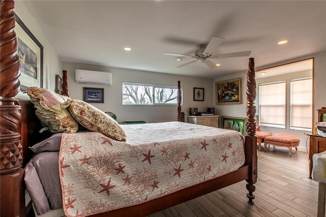 bedroom with baseboards, ceiling fan, wood finished floors, a wall mounted AC, and recessed lighting