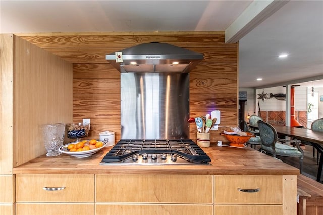 kitchen featuring stainless steel gas cooktop, wooden counters, and exhaust hood