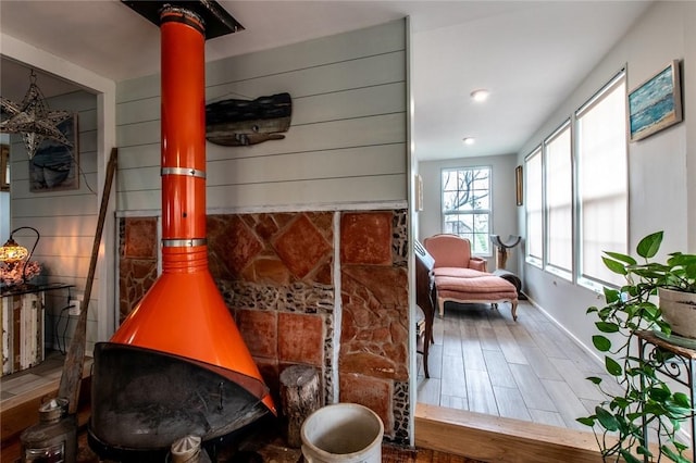 interior space featuring a wood stove and wood finished floors