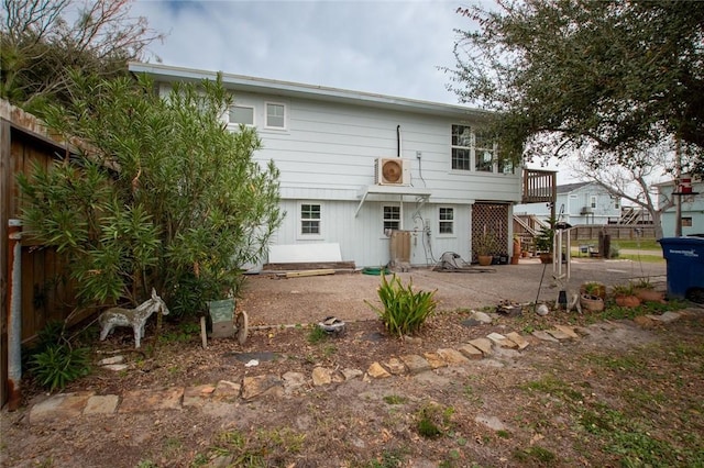 view of front of house featuring a patio area, fence, and stairway