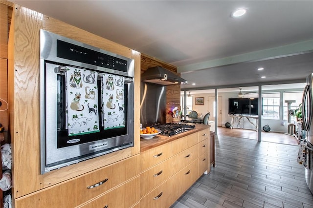 kitchen featuring light brown cabinets, recessed lighting, wood finished floors, appliances with stainless steel finishes, and ventilation hood