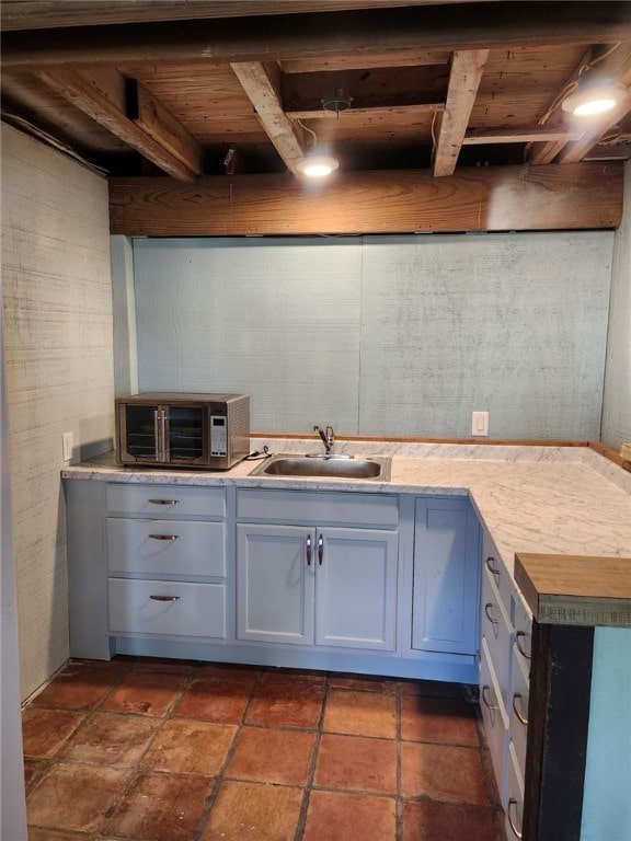 kitchen featuring light countertops, a sink, and a toaster