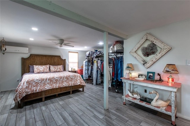 bedroom featuring wood tiled floor, beam ceiling, an AC wall unit, and recessed lighting