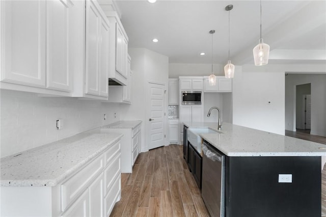 kitchen with white cabinets, pendant lighting, an island with sink, and stainless steel appliances