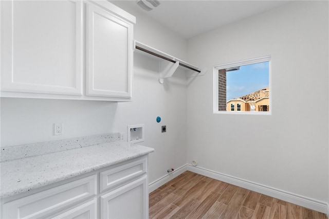 laundry area featuring cabinets, hookup for a gas dryer, washer hookup, hookup for an electric dryer, and light hardwood / wood-style floors