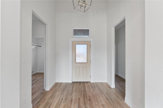 entrance foyer with a chandelier and light hardwood / wood-style floors