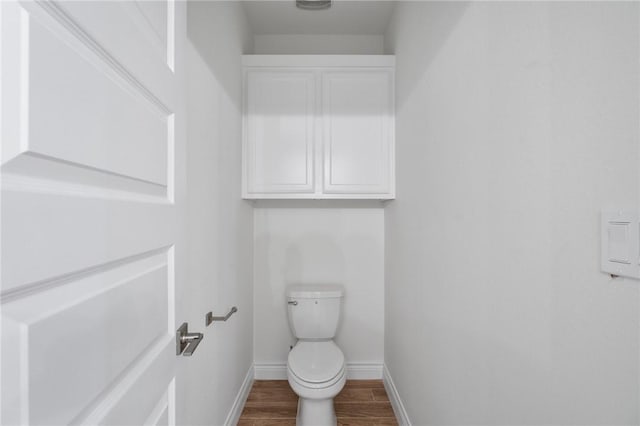 bathroom featuring hardwood / wood-style floors and toilet