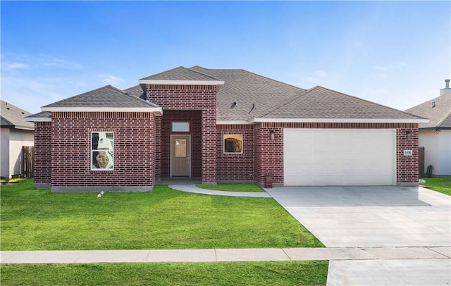 view of front facade with a front yard and a garage