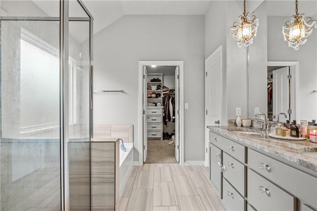 bathroom featuring high vaulted ceiling, vanity, independent shower and bath, and an inviting chandelier