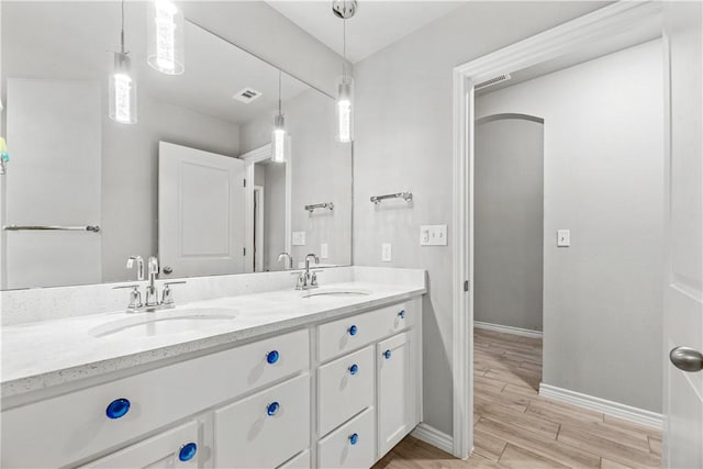 bathroom with vanity and hardwood / wood-style flooring