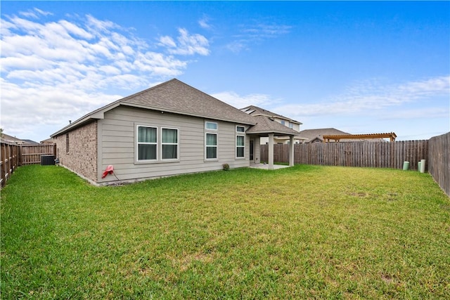 rear view of house featuring a yard, a patio, and cooling unit