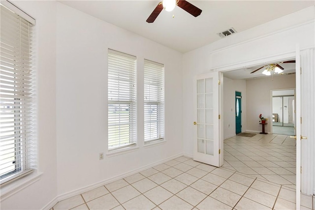 8101 Mt Zion, Corpus Christi, TX 78413 - empty room with a ceiling fan, french doors, and light tile patterned flooring