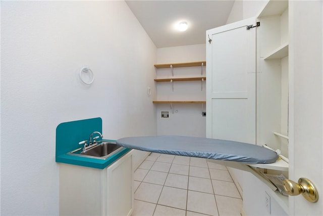 unfurnished bedroom featuring a sink and light tile patterned flooring