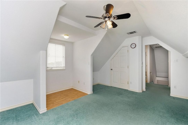 additional living space featuring vaulted ceiling, carpet, visible vents, and baseboards