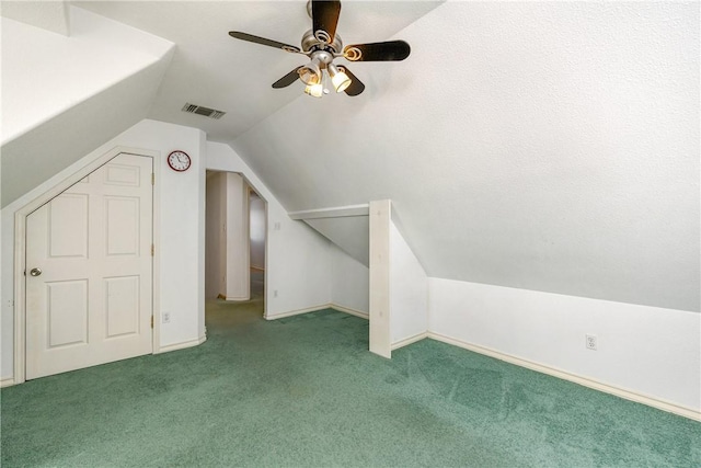 additional living space featuring lofted ceiling, ceiling fan, carpet floors, visible vents, and baseboards