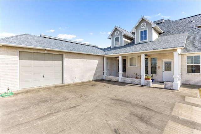 8101 Mt Zion, Corpus Christi, TX 78413 - view of front of home with brick siding, a porch, concrete driveway, an attached garage, and roof with shingles