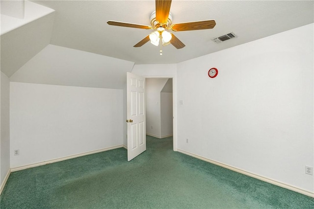 interior space with lofted ceiling, carpet floors, visible vents, baseboards, and a ceiling fan