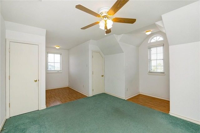 bonus room with lofted ceiling, ceiling fan, and carpet flooring