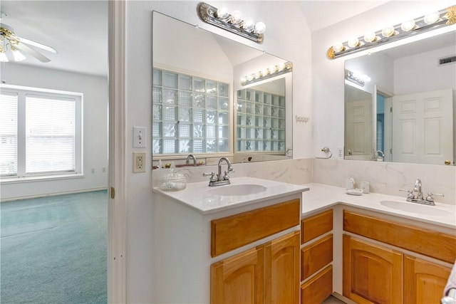 bathroom with a ceiling fan, visible vents, a sink, and double vanity