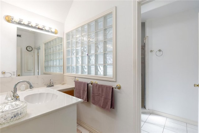 full bathroom featuring tile patterned flooring, a sink, lofted ceiling, and double vanity