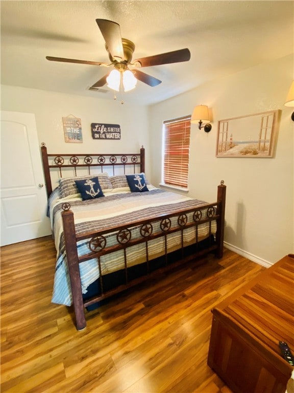 bedroom with ceiling fan and wood-type flooring