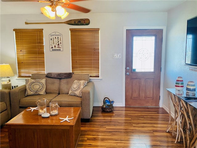 living room featuring dark hardwood / wood-style flooring and ceiling fan