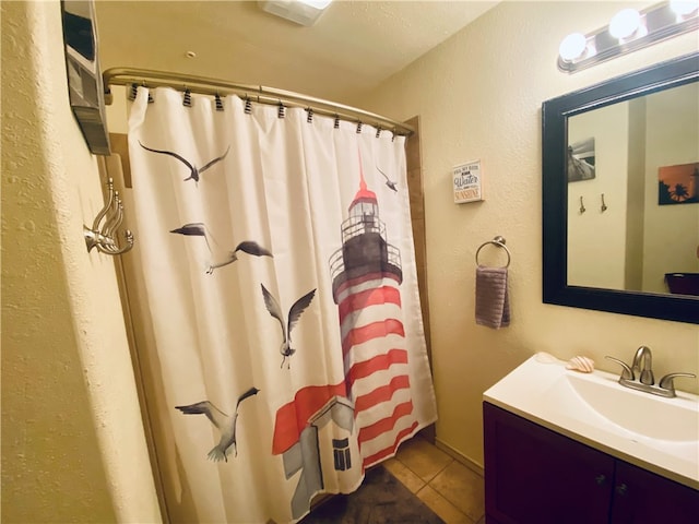 bathroom with vanity, a textured ceiling, tile patterned floors, and a shower with shower curtain