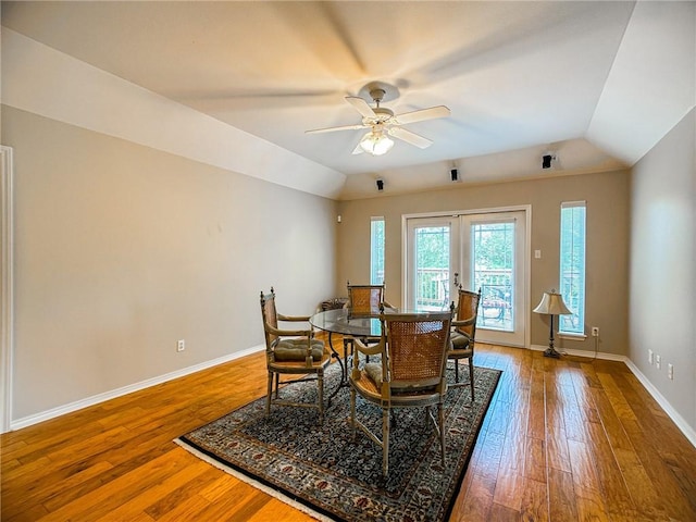 dining space featuring lofted ceiling, hardwood / wood-style floors, and french doors