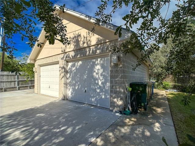 detached garage featuring fence