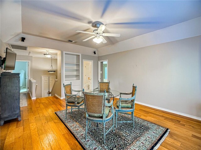 dining area with light wood finished floors, baseboards, and visible vents