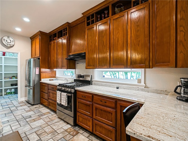 kitchen featuring open shelves, under cabinet range hood, brown cabinets, and stainless steel appliances