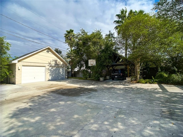 exterior space with a garage, an outbuilding, and fence