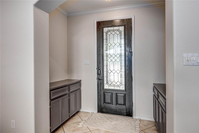 foyer featuring light tile patterned floors, baseboards, and ornamental molding